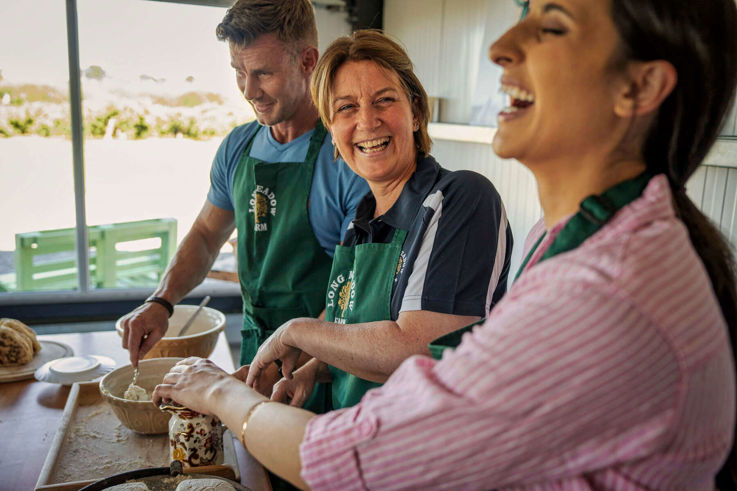 Visitors baking bread as part of Long Meadow Orchard Cider Experience