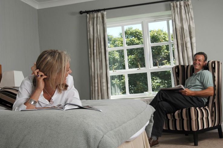 Ballygally Castle Hotel residents reading the hotel's guest information pack.