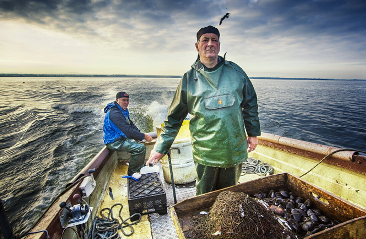 Fisherman out on their fishing boat, ready to catch some eels on Lough Neagh