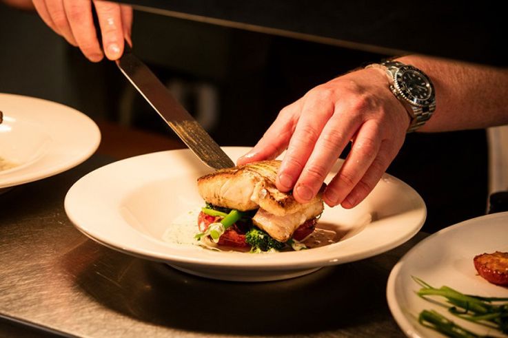 Chef preparing a fish dish at the Mourne Seafood Bar, Belfast