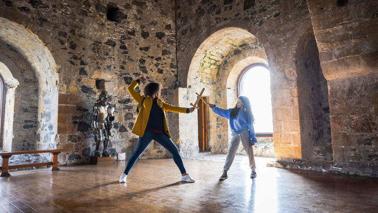 Mother & child playing with swords in Carrickfergus Castle