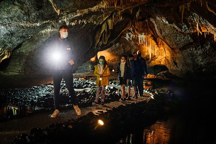 Tour guide with PPE giving Marble Arch Caves tour