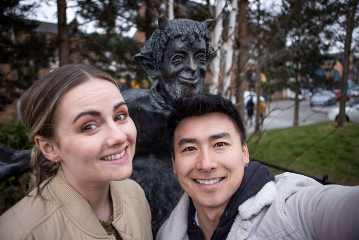 Young couple taking photo during their C.S Lewis Walking Tour